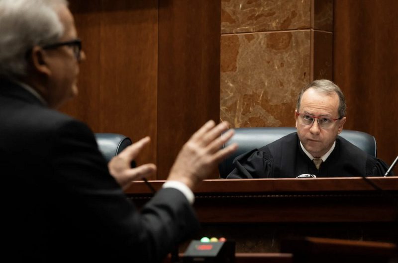 man talking to judge in court room